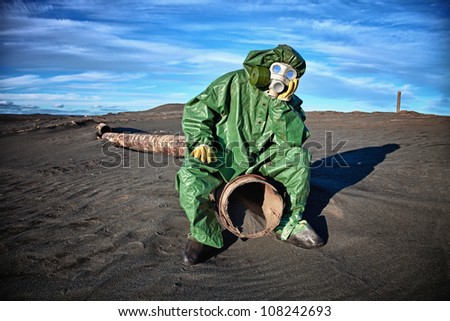 Man in protective clothing in the area of ??environmental disaster