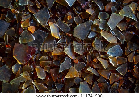 Old dirty glass shards on the ground - industrial waste grunge background