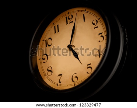 Antique clock dial on dark background