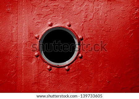 Porthole On The Red Wall Of The Old Ship