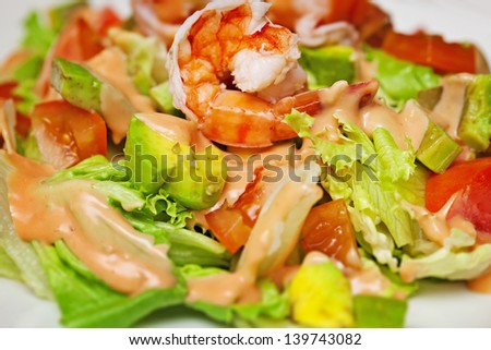 Salad with shrimp and avocado close-up
