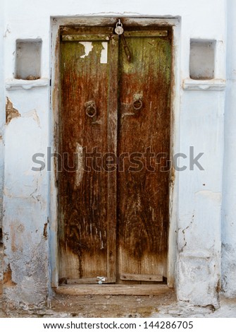 Rotten wooden grunge door of an old house. India, Udaipur