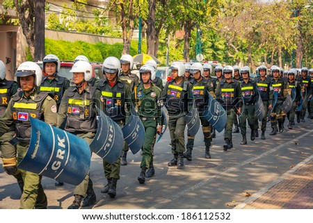PHNOM PENH, CAMBODIA - 29 DEC 2013: Cambodian riot police march on a central streets