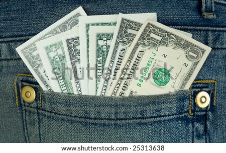 Dollars jut out on hip-pocket jeans close up
