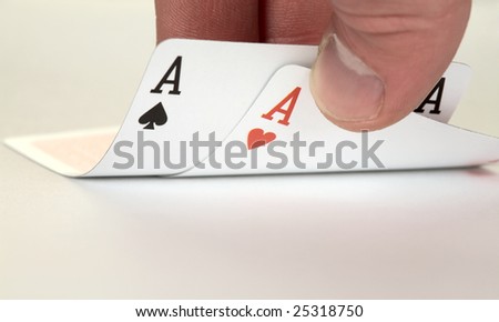 The ace of hearts and ace of spades on hand