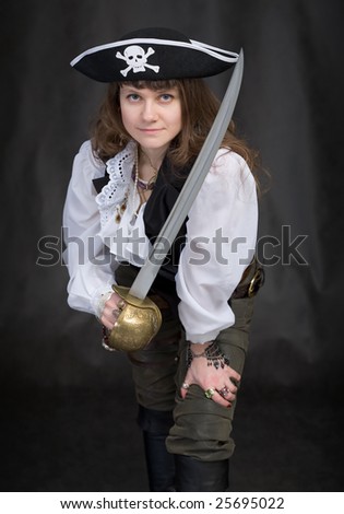 The girl - pirate with a sabre in hands on a black background