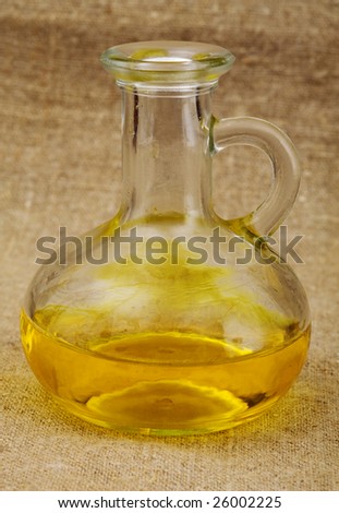 Carafe with yellow oil on canvas background