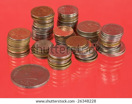 Rolls of the metal russian coins on red background