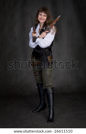 The girl - pirate with two ancient pistols in hands on a black