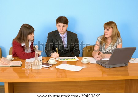 Business team sits at the big table