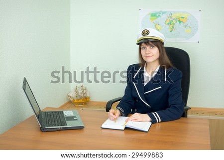 Girl - the sea captain at office with the laptop