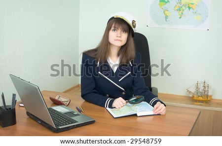 Girl - the sea captain with a atlas in office