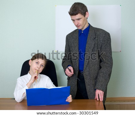 Teacher in a suit and schoolgirl with book