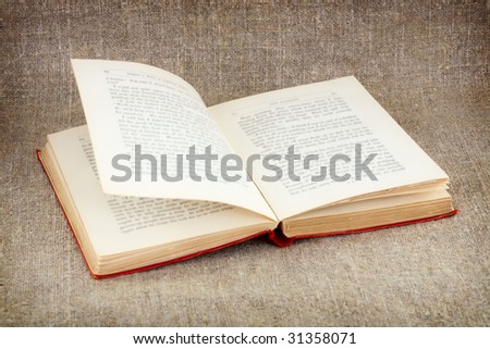 Open big old book on canvas background