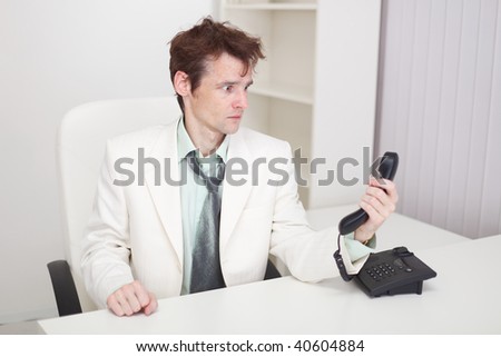 The businessman has finished difficult telephone conversation