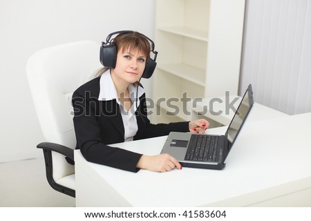 The young woman with the big stereos ear-phones on a head