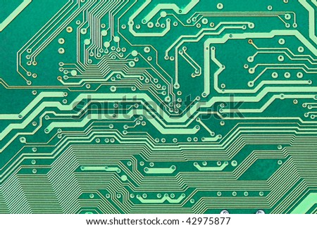 Texture of an electronic plate of green color with metallic paths
