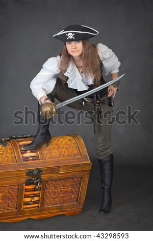 The sea pirate with a sabre and the big chest of treasures
