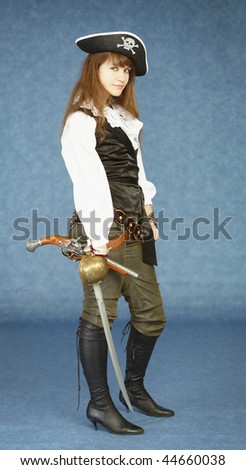 The young woman in clothes of the pirate on a dark blue background