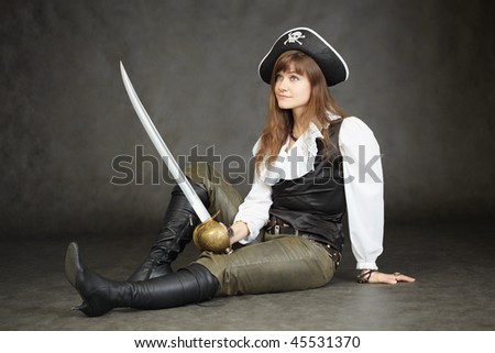 Woman - the captain of the pirates sitting on a black background with a sword