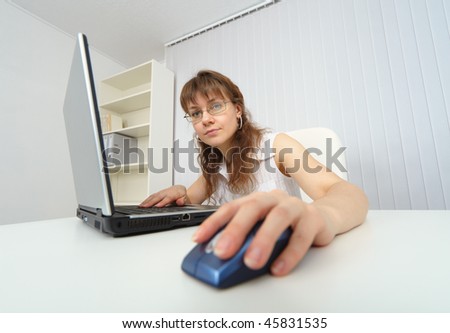 Young woman working with laptop photographed comic foreshortening