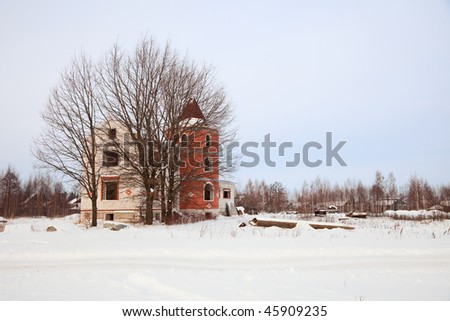 Winter landscape with unfinished mansion and tree