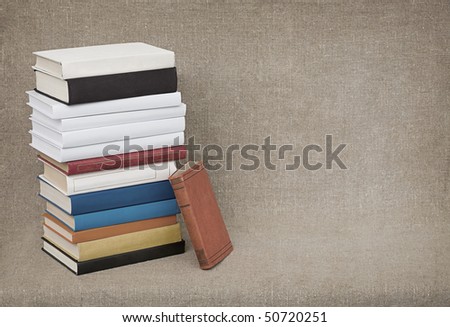 The high pile of old books and textbooks on the background of the canvas