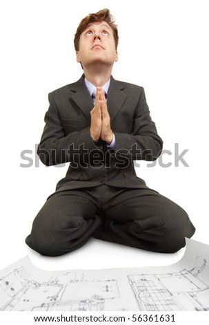 Engineer prays to God while sitting on the floor beside the documentation