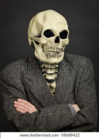 Portrait of the person in a skeleton mask against a dark background