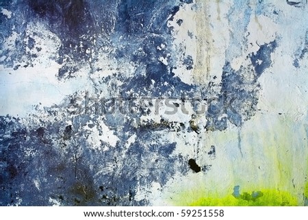 Ragged concrete wall with color stains of a paint