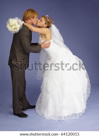 The bride and groom funny kiss on purple background