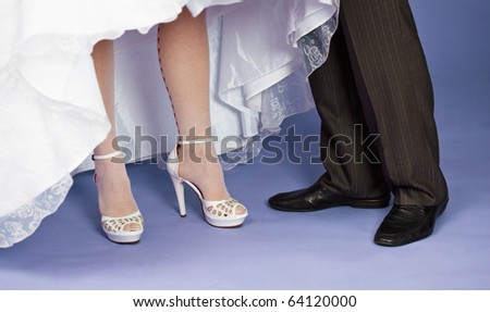 Feet of the groom and the bride - a wedding composition