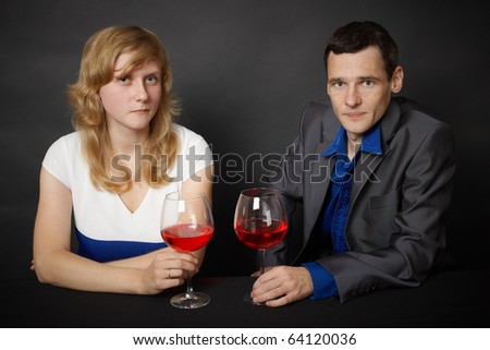 Man and woman drinking red wine in the evening at the table