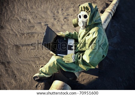Scientist with laptop in zone of ecological disaster