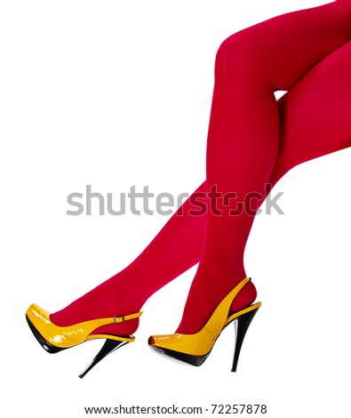 Beautiful women's feet in the yellow shoes and a crimson tights