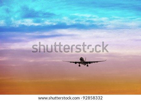 Passenger plane takes off at sunset