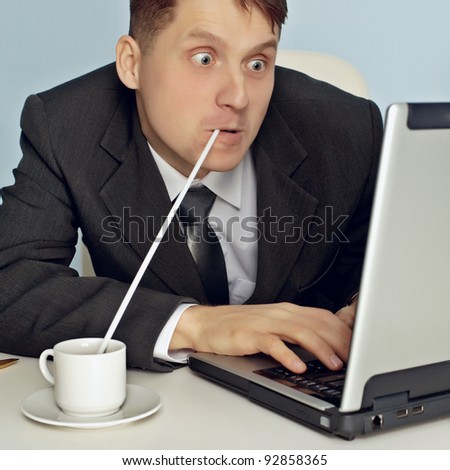 Funny businessman drinking coffee and working
