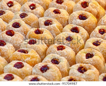 Ready-made donuts covered with powdered sugar on a tray