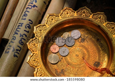 Coin in thai style golden tray. make merit, donation