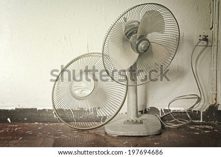 Dirty on old electric fan,Old electric fan, Cooling fan, Electric fan in hot weather. Process in warm tone color.