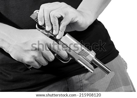 Close up of man\'s hand reloading gun, Man hold and loading ammunition his pistol on white background. Army, Semi-automatic handgun, 45 pistol, Black&White.