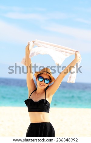 Beautiful Girl With Scarf Jumping on The Beach. Travel and Vacation. Freedom Concept.