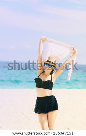 Beautiful Girl With Scarf Jumping on The Beach. Travel and Vacation. Freedom Concept. (Color Process)