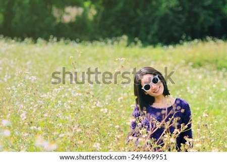 Asian woman in golden dried grass field. Girl in flower field.