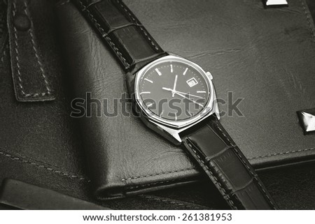 Vintage watch on a brown leather wallet. Classic Wristwatch.