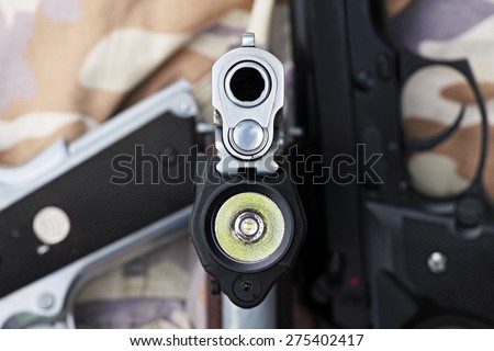 Aimed Semi Automatic Pistol, Handgun aimed at you, 45 pistol, Close-up Barrel, Selectively Focused on the front of the gun.