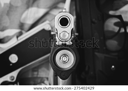 Aimed Semi Automatic Pistol, Handgun aimed at you, 45 pistol, Close-up Barrel, Selectively Focused on the front of the gun. (Black & White)