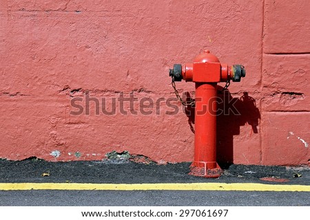 Red fire hydrant, Red connecting hydrant against the wall.