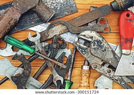 Dirty set of hand tools, Set of tools over a wood panel, Building and measuring tools.