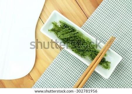 Seaweed Salad, Healthy sea food in the dish. Oval sea grapes seaweed. Healthy Food.